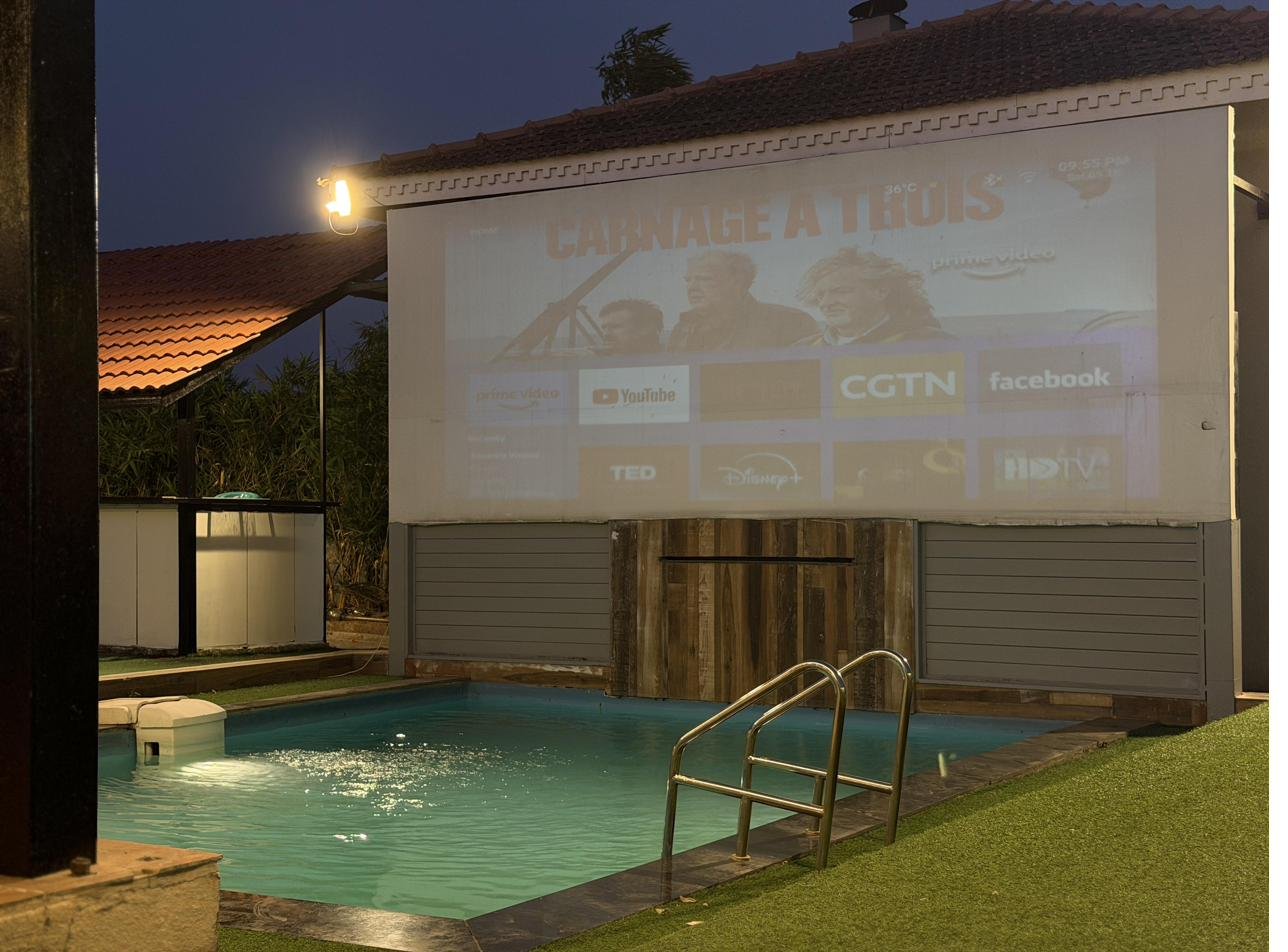 Outdoor cinema by the pool at night